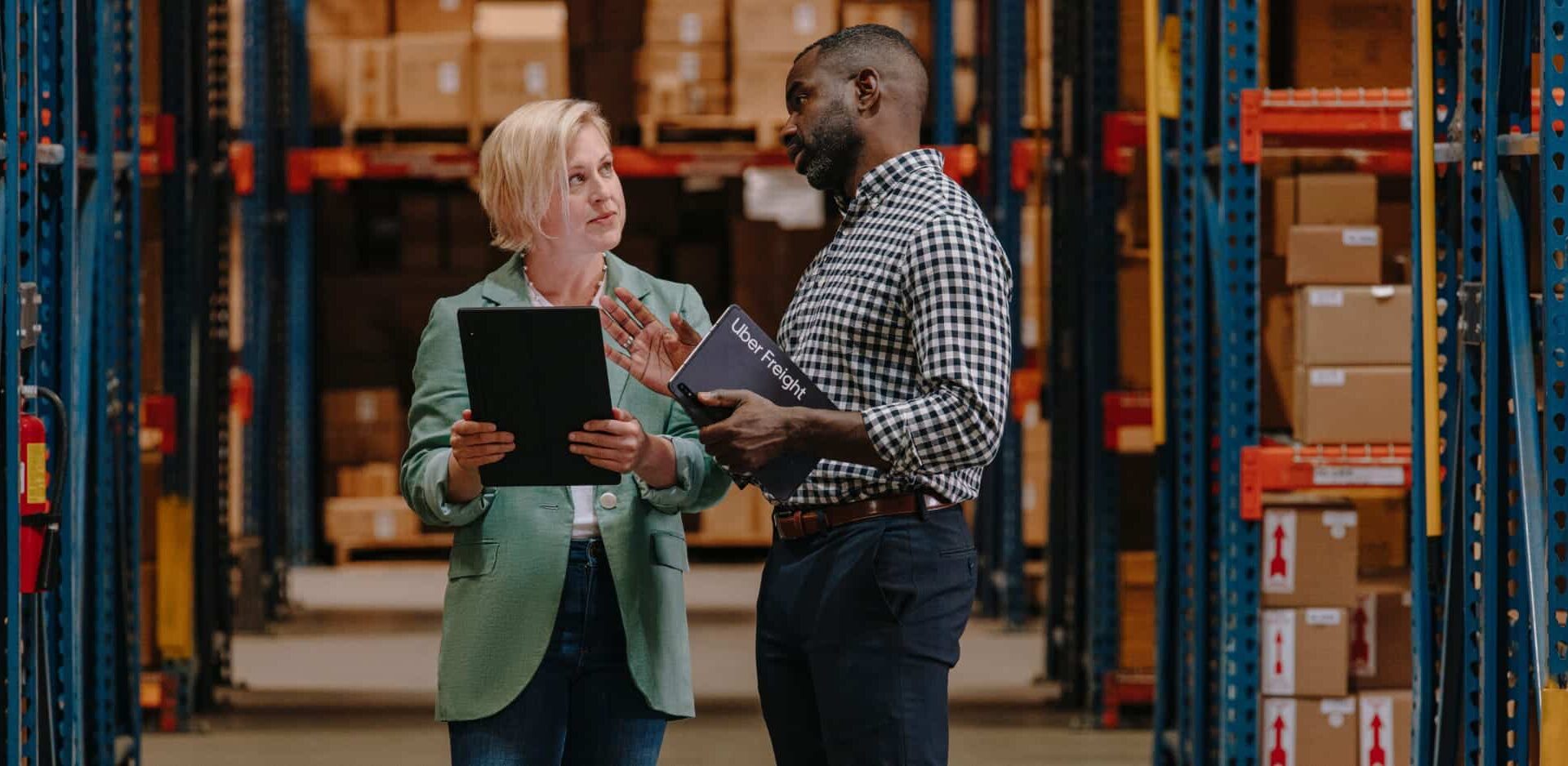 UF_SHIPPER_WALKTHROUGH_A_0059_R1-2 two people discussing something in warehouse